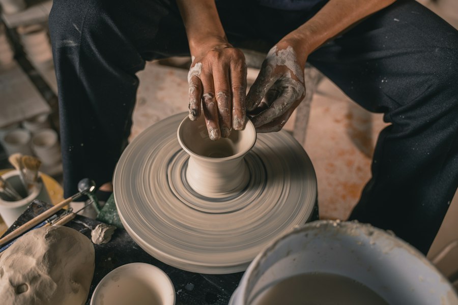 Hands shaping clay at a pottery workshop